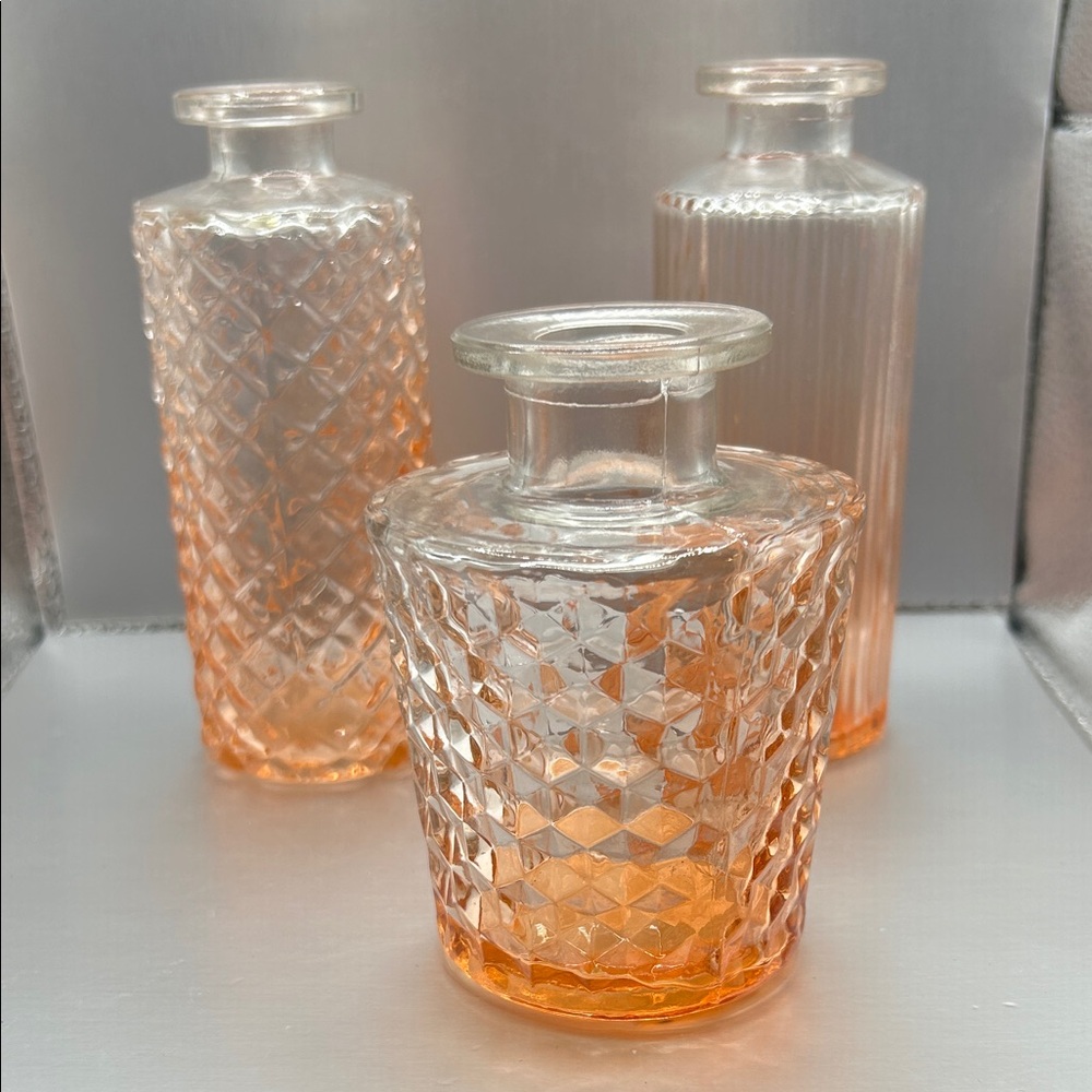 Set of three clear and orange glass bud vases